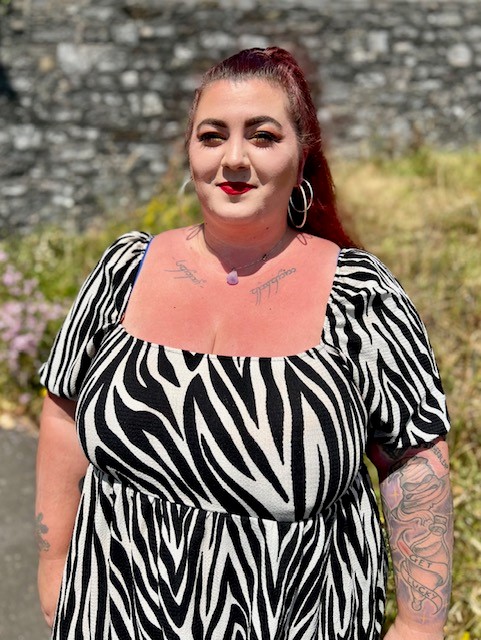 Picture of Vicki smiling wearing a black and white dress