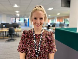 Woman with blond hair smiling in office