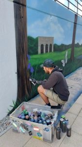 Man spray painting a wall