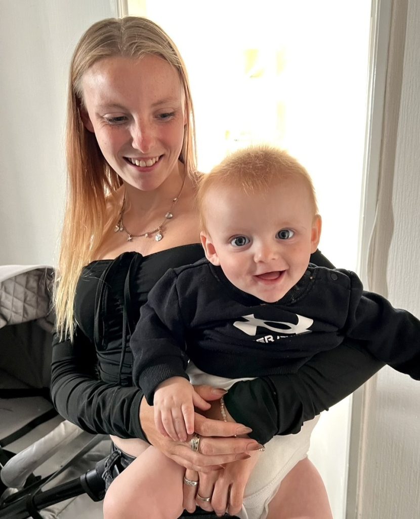 Young woman holding toddler