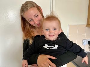 Young woman holding toddler