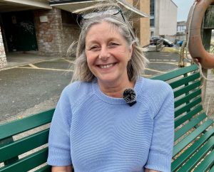 Woman in blue jumper smiling