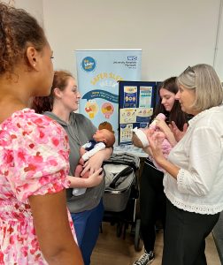 Four women, two holding babies