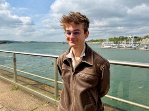 Young man smiling by the sea