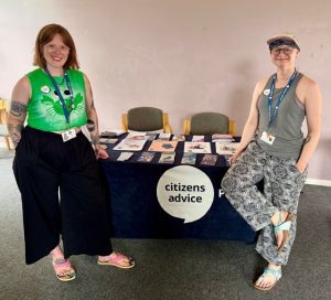 Two women sat either side of an information desk
